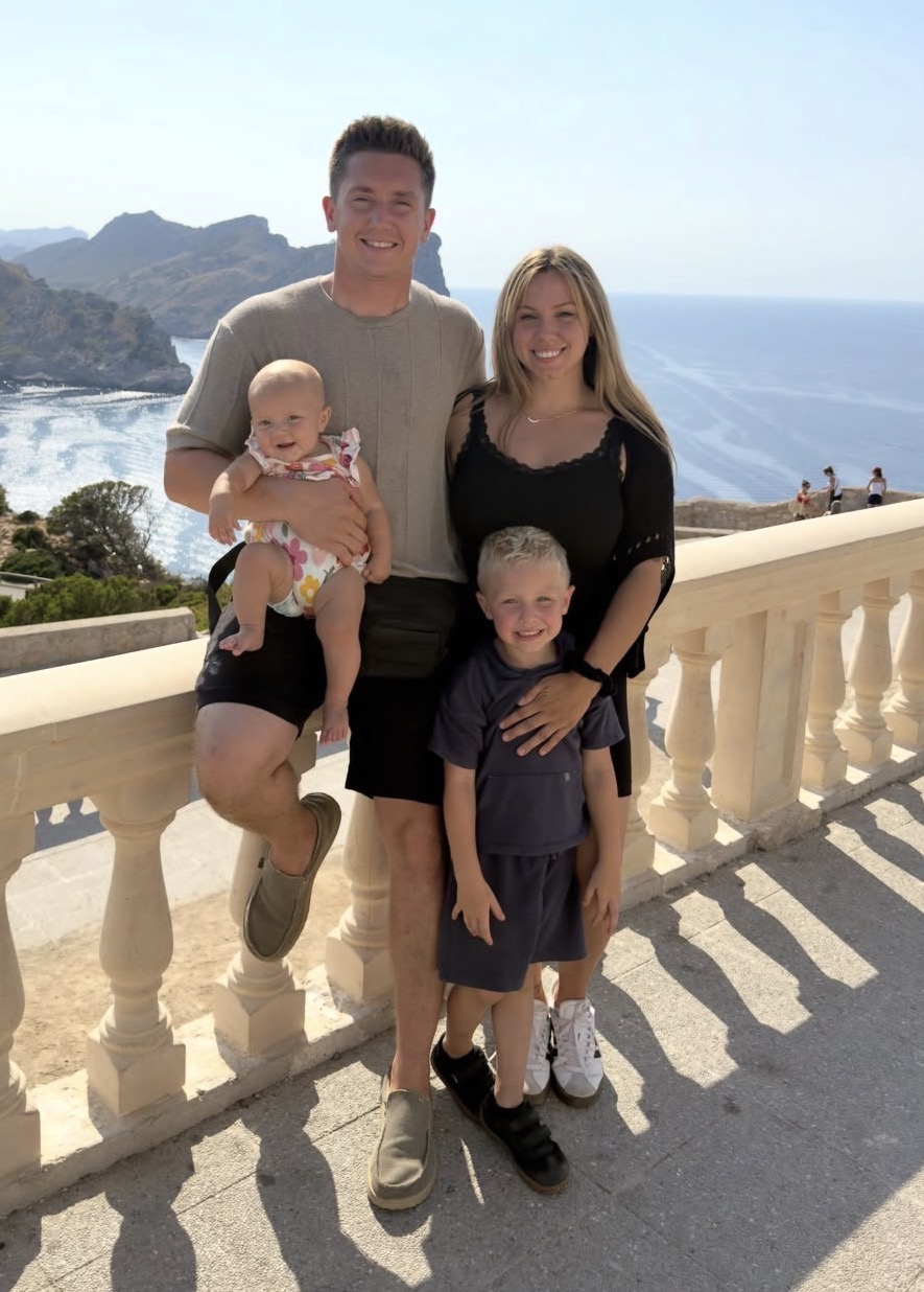 Balazs Busznyak with his wife and two children overlooking the water
