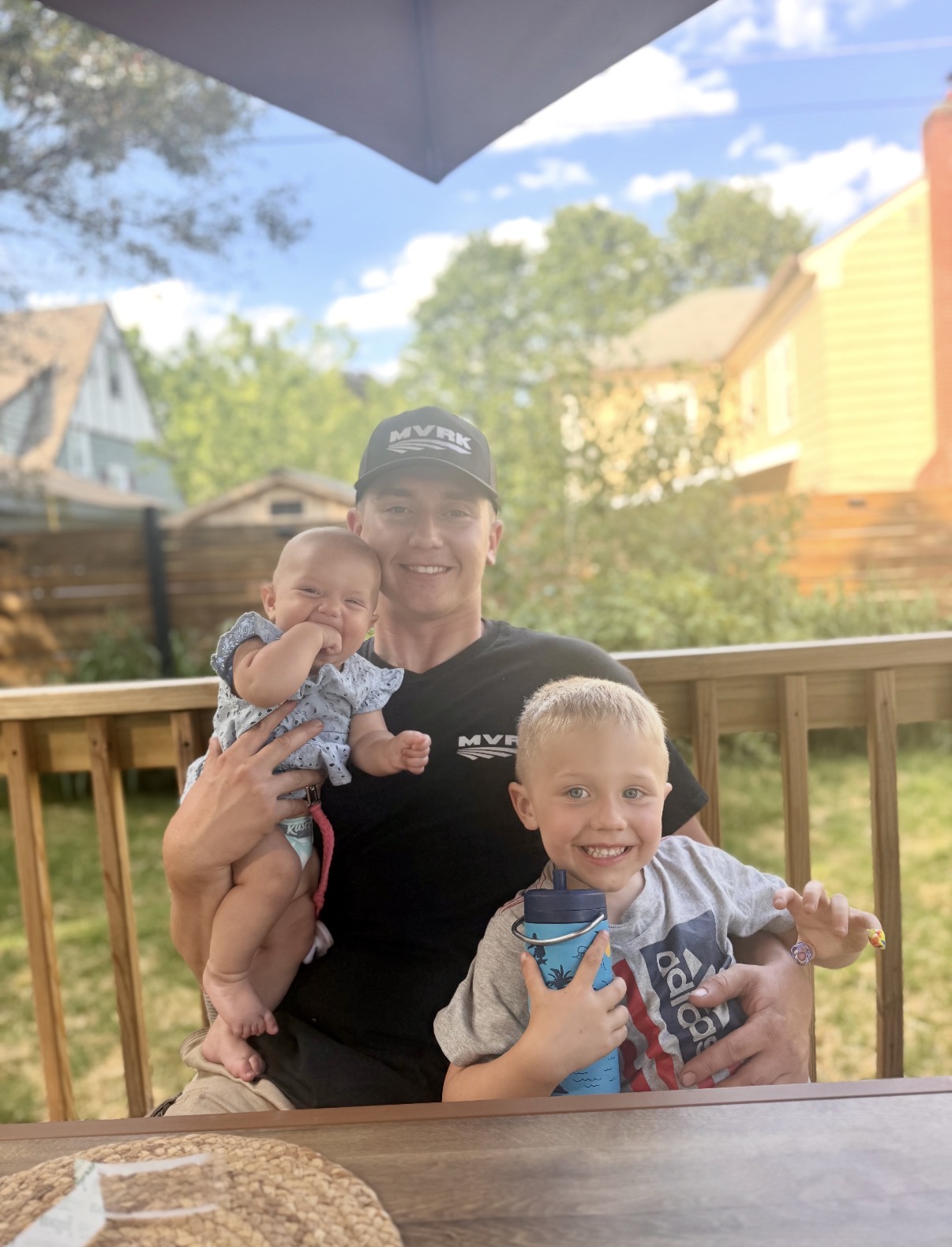 Balazs Busznyak with his kids in the backyard